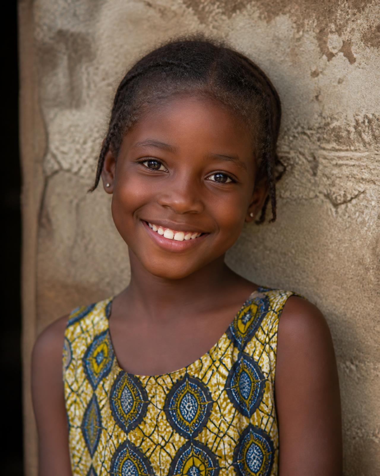 Smiling young girl in a rural sub-Saharan African community served by ACBF